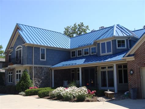 dark blue house cedar post dark metal roof|blue roof house.